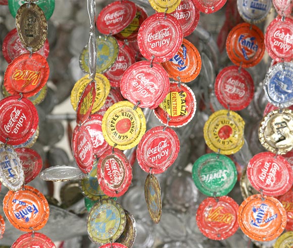 Chandelier made from flattened bottle caps.  One light (can easily be converted to more).