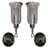 mirrored sconces with starburst etchings and fluted glass shades