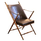 Leather campaign chair with carved bamboo frame and brass trim