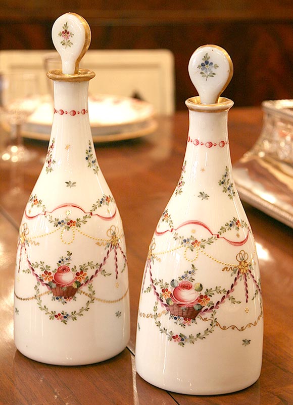 Pair of exceptional French Louis XVI period handblown opaline decanters with hand-painted and gilt decoration of flowers, swags and ribbons, original stoppers, circa 1780.