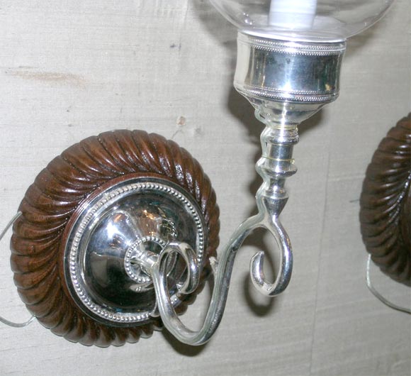 Pair of wood backplates with silverplated sconces and globes In Good Condition For Sale In Jersey City, NJ