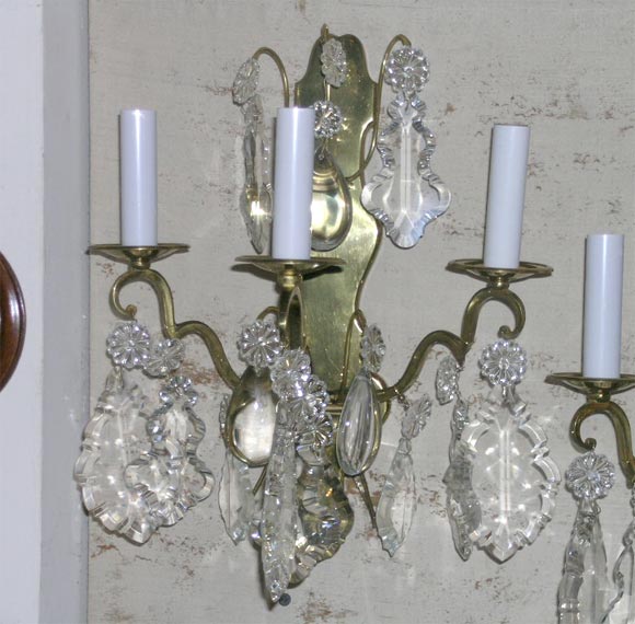 pair of antique bronze and crystal sconces, wired.