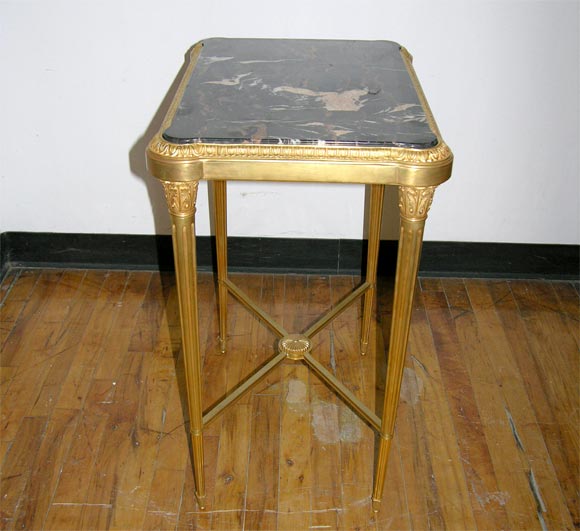 A fine pair of gilded bronze portor marble top end tables.