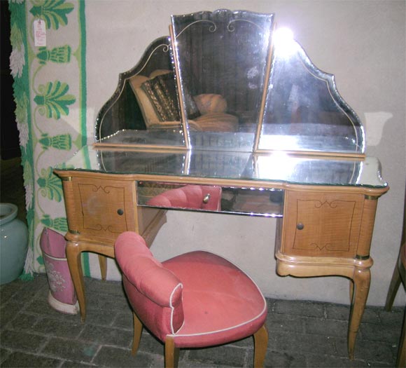 French sycamore and bronze mounted dressing table with beveled mirror drawer fronts. Upholstered French slipper chair.