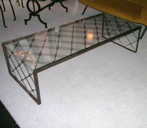 I am very proud to offer this very rare eiffel base coffee table by Jean Royere, rare long version with original glass and patina. this design is seldom seen on the market, it is alongside the 