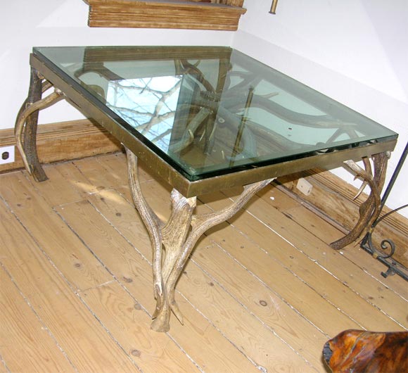 Square glass top table with base of antlers