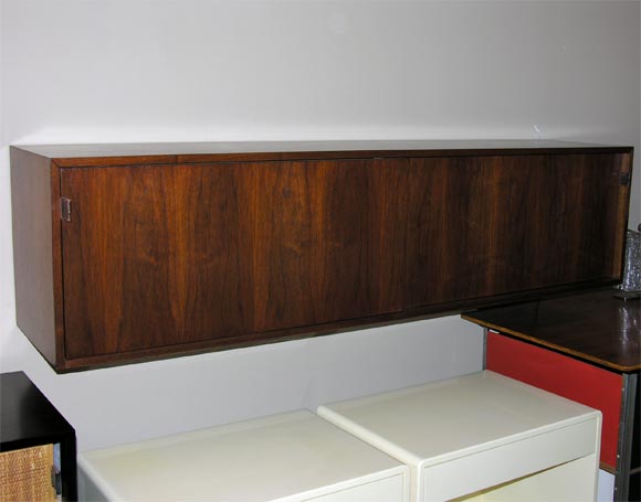 walnut hanging credenza with leather pulls and glass shelves
