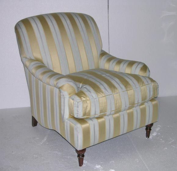 true to the traditional English style created by Howard and Sons circa 1910. <br />
Deep 50/50 Feather and Down cushion and tight back. <br />
Upholstery material is a traditional stripe of blue and gold woven silk.