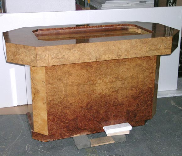 A  burlwood center table with a tv lift  att  to KARL SPRINGER