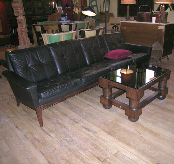 coffee table with massive turned leg and dark glass top
