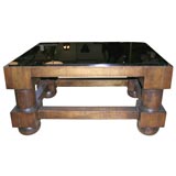 coffee table with massive turned leg and dark glass top