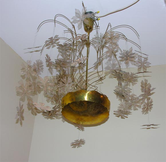 An exceptional Paavo Tynell brass snowflake chandelier.Four snowflake designs. Five light sources. Brass bowl with perforated holes in a decorative design. Rare.