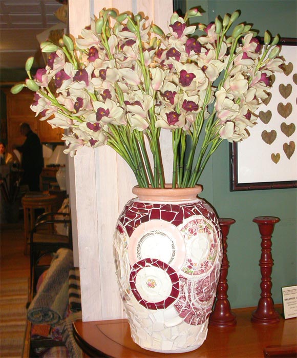Custom mosaic vases miticulously hand-laid with pieces of old, fine, shattered china.