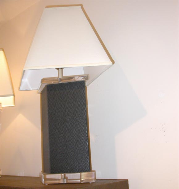 A PAIR OF LUCITE AND FAUX SNAKESKIN LAMPS.