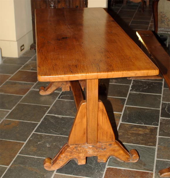 Spanish Colonial (Phillipines) molave wood refectory table, the rectangular planked top raised on tapering trestle supports, resting on scrolled, burled feet, joined by a square stretcher.