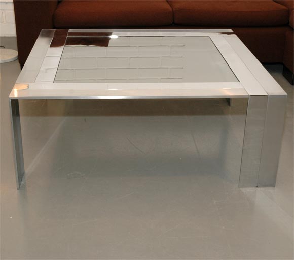 coffee table by Pierre Cardin, base has alternating pieces of chrome and brushed steel with a mirrored glass top.