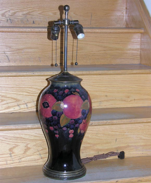 Single Moorcroft table lamp with peach and grape motif.