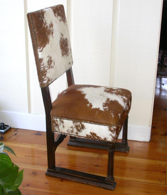A Fine English Hall Chair upholstered in Argentinian Cow Hide and Antique nail head trim.