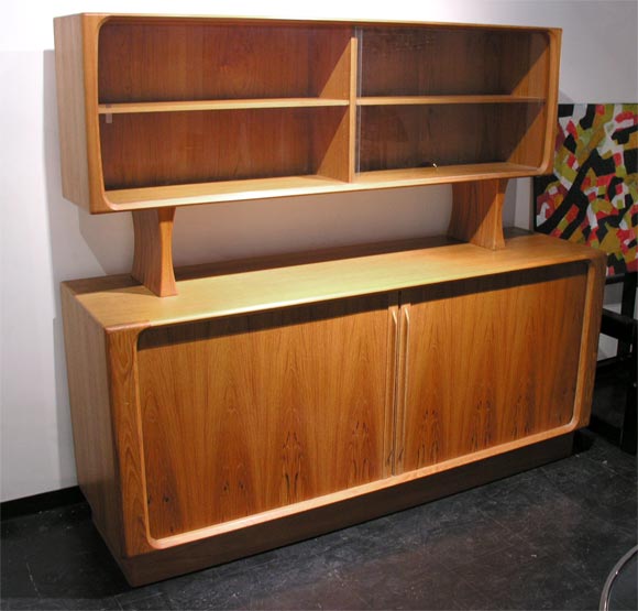 Botom of buffet measures 71 long 32 high and 20 deep.  it is outfitted with 8 shelves and 3 pullout drawers great for silver ware.  Sliding doors disappear into buffet.    Top piece measures 65 long 30 high and 12.5 deep.  It has glass sliding doors.