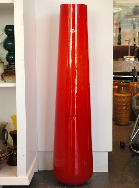 Gigantic Red glass cased floor vase with original sticker.The opening diameter is 6 inches and it goes down to 7.5 inches at the bottom.