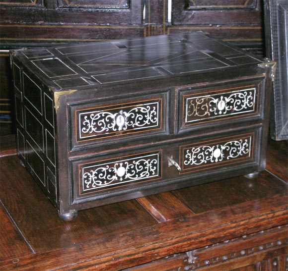 Handsome 17th century Indo-Portuguese table-top chest having two short over one long drawer, ebony veneer with bone inlay, the top and sides with geometric inlay, the drawers with scrollwork designs.