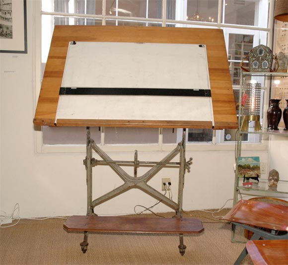 Large adjustable drafting table with foot rest.