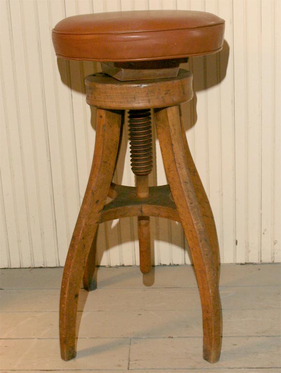 Adjustable artist's stool with leather upholstered top, late 19th century.