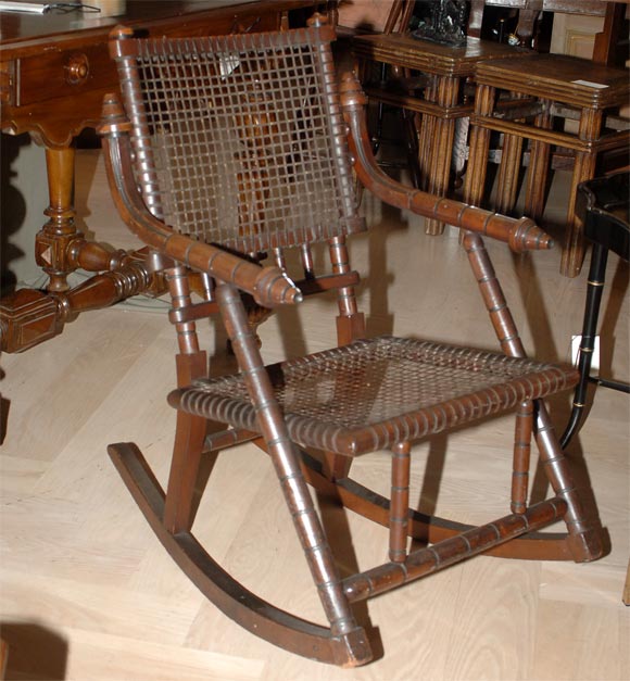 A rare signed rocking chair with original finish.  Hunzinger was one of Americas leading furniture designers during the second half of the 19th Century.