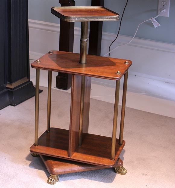 Diminuative revolving bookstand in mahogany with brass supports and paw feet