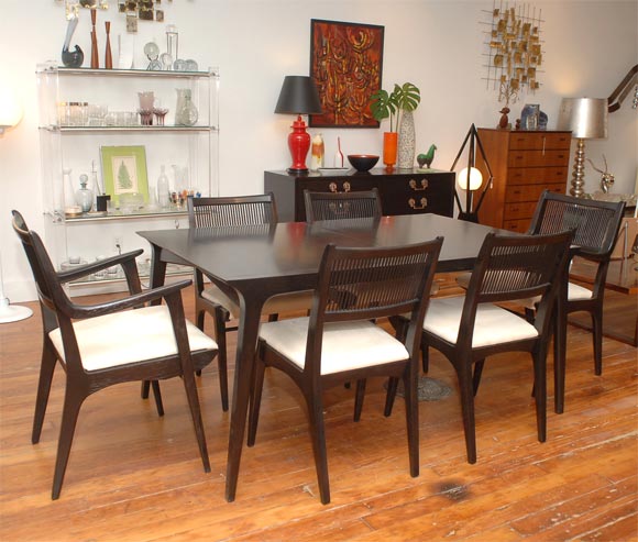 Sophisticated dining set by Drexel's profile line, comprising a table with three leaves and six chairs four side and two arm. Refinished in a bittersweet chocolate lacquer and upholestered in ultra-suede.