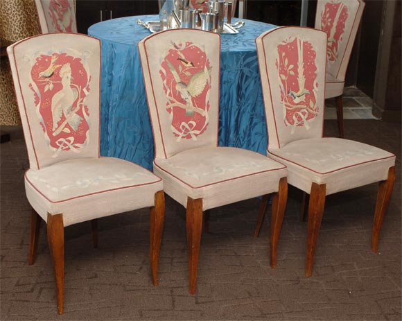 Each with a shaped back upholstered in Aubusson tapestry depicting exotic birds within ribbon-framed deep smokey rose colored cartouches on a buff ground outlined in rose silk piping; the upholstered seat supported by two serpentine front legs and