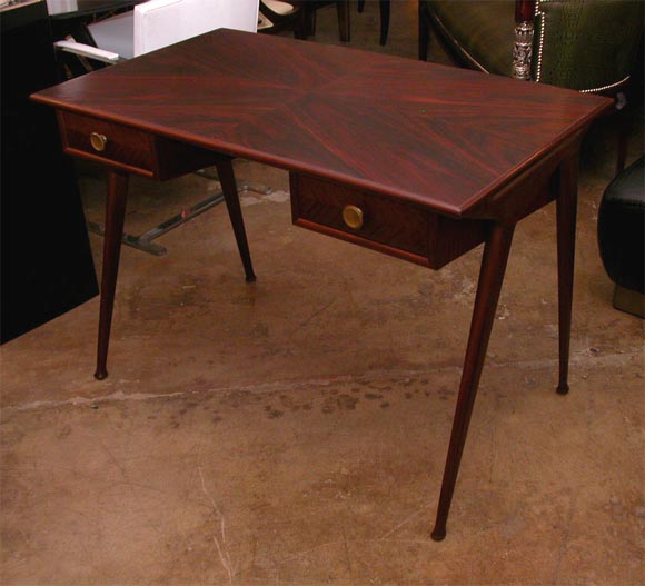 A Rosewood and mahohgany and Zebrano wood,By The Italian Architect Carlo De Carli.The Aerodynamic shape and the asymmetric design of the legs are  a classic De carli signature.<br />
this 