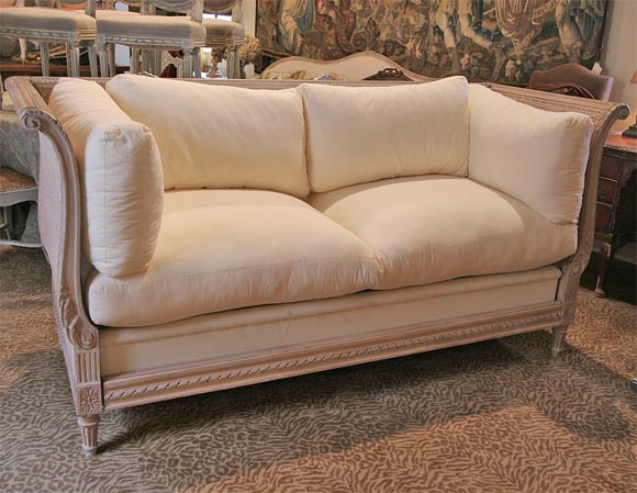 Wonderfully comfortable settee with painted cane back and sides.  This does disassemble.  Would make great daybed for guest room.