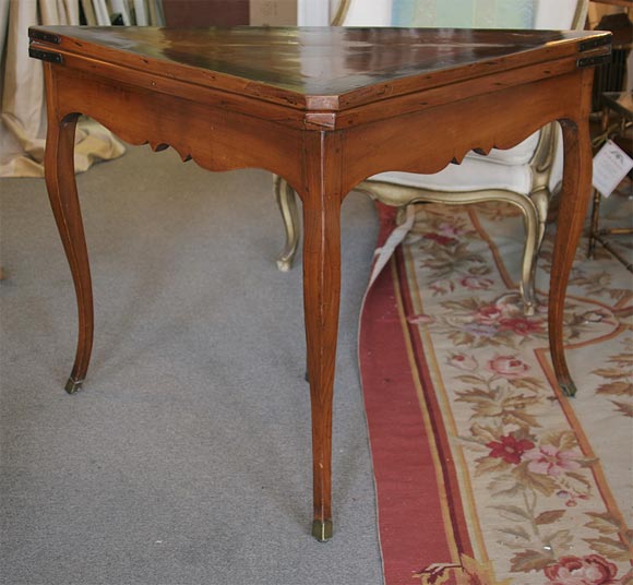 French walnut, Louis XV style, open top game table with brown siena leather top, revealed when open.  When closed, the triangular walnut veneer top with decorative inlaid banding is visible. The table is 28 1/2