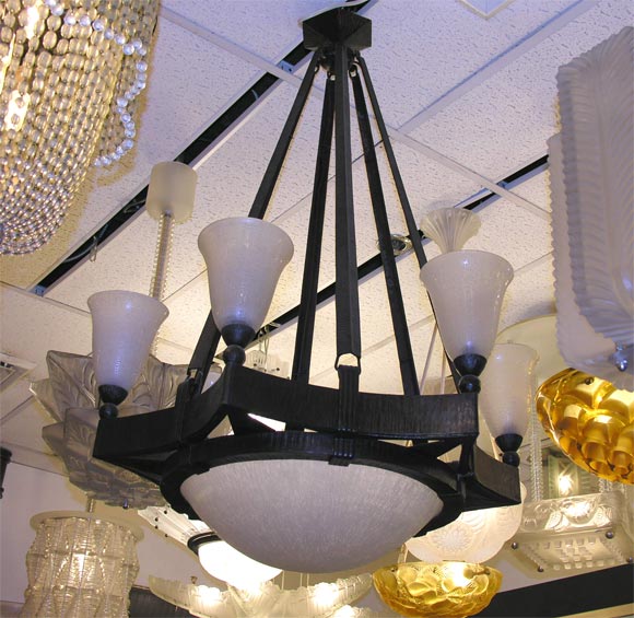 Wrought iron chandelier by Brandt, frosted glass shades by Daum, signed.