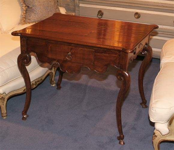 French Louis XV Period Provencal Chestnut Writing Table,<br />
exquisitely carved and with three drawers.