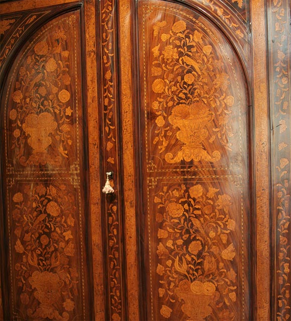 Dutch marquetry armoire with exceptional marquetry of flowers, birds and butterflies. Feet are replacements but appropriate for the style and proper age.