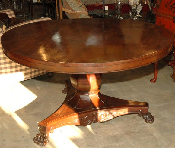 carved pedestal  mahogany  table with clows feet