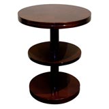 A pair of Modernist round side tables with lower shelf.