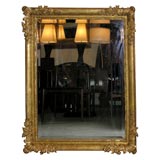 A fine Baroque frame now fitted with a beveled mirror.