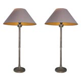 A pair of brass candlestick lamps