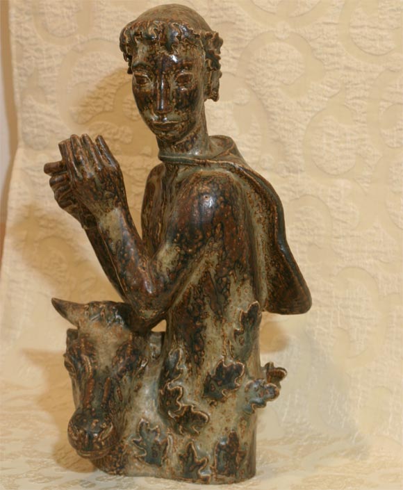 Beautiful sculpture of a boy playing Pan's pipes and the head of a faun by Helge Christensen for the Royal Copenhagen Porcelain Factory.  Pottery in prized 'Sung' glaze.   Danish modern, 20th century pottery