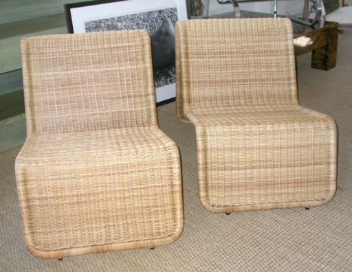A pair of wicker lounge chairs.