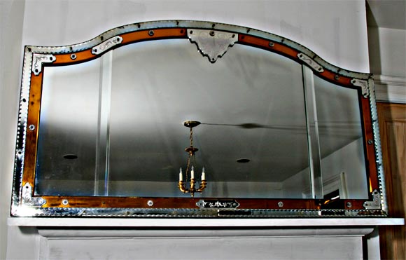 An arched-top Venetian overmantel mirror with amber glass accents. Amber glass is more the color of that in the lighter photos.  the over height is 36