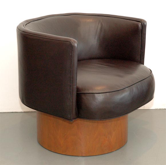 Chocolate brown leather with walnut base swivel bucket chairs.