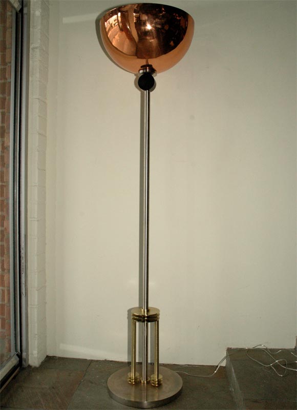 A very tall 1930s moderne torchiere made of copper, brass and brushed steel.