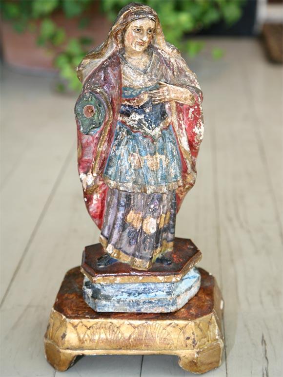 Polychrome statue of a female saint.