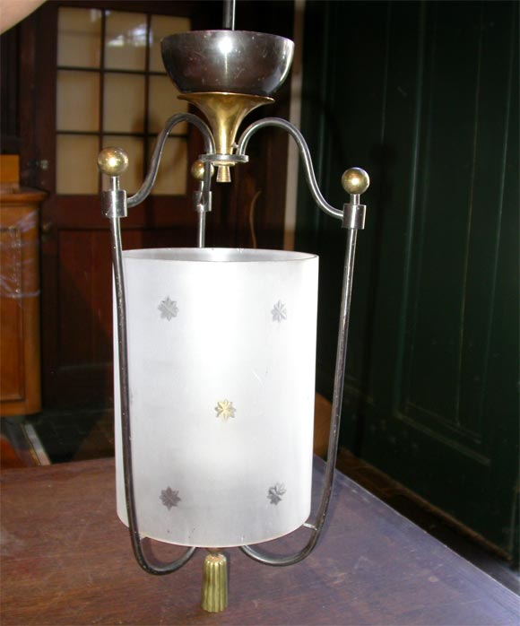 Cylindrical etched glass, wrought iron lantern with bronze trim.