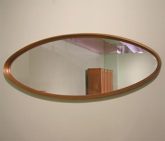 Sinuous oval gold gilt wood framed entry mirror by LaBarge. U.S.A., circa 1950.