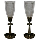 A Pair of Tommi Parzinger Brass and Glass Hurricane Lamps.